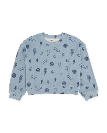 A light blue crewneck sweatshirt with an all-over dark blue graphic print of skateboards, lightning bolts, smiley faces, and other doodles