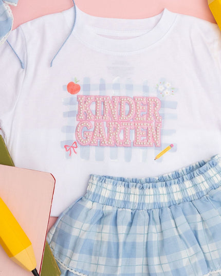 White t-shirt with pearl patch that reads Kindergarten