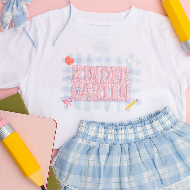 White t-shirt with pearl patch that reads Kindergarten
