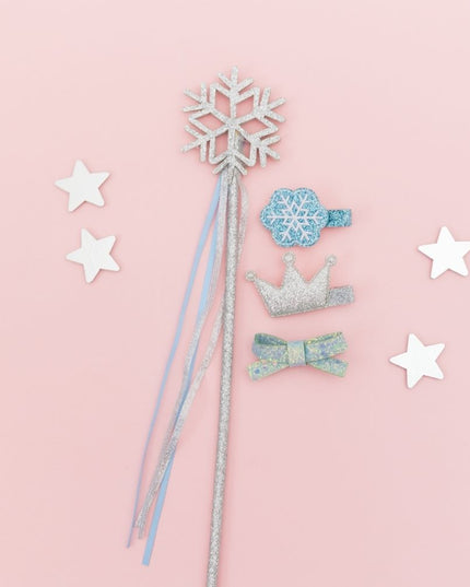 Flatlay showing silver snowflake wand and hair clips