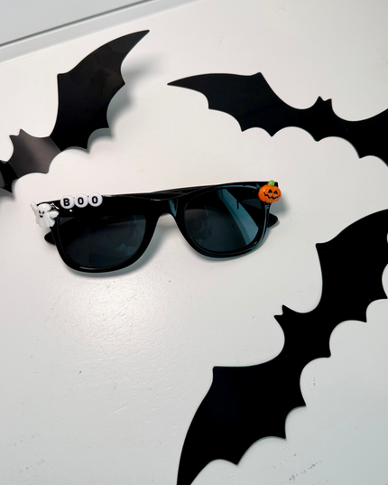 Black Sunglasses that say Boo and have a ghost and pumpkin charm