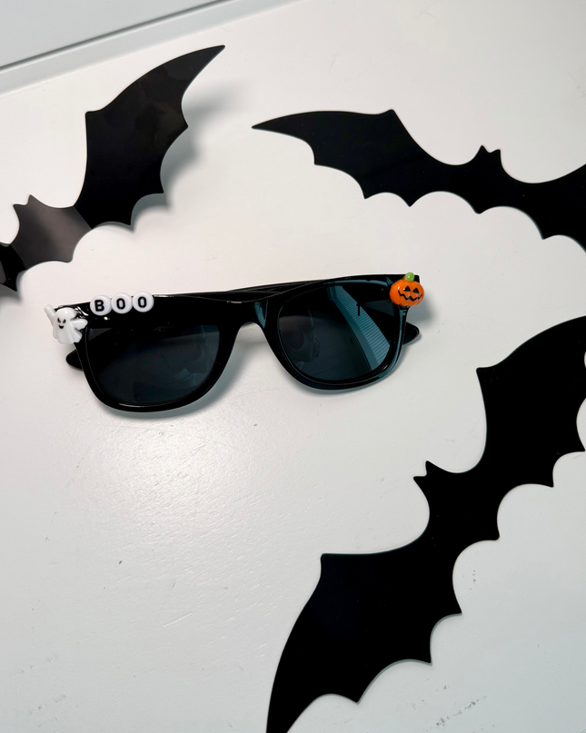 Black Sunglasses that say Boo and have a ghost and pumpkin charm