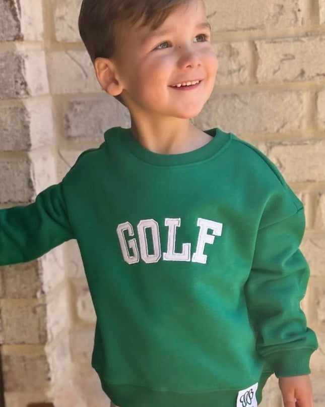 boy wearing green sweatshirt with white golf appliqué 