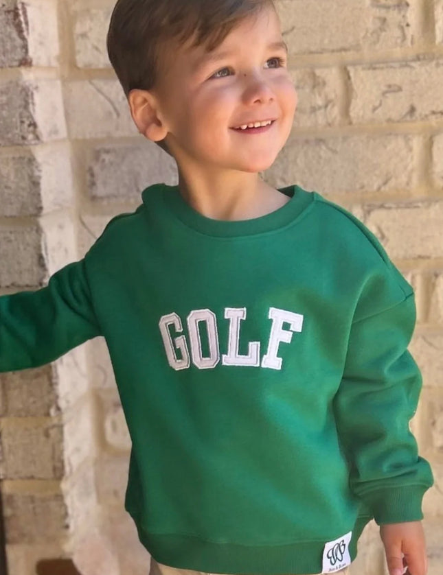 boy wearing green sweatshirt with white golf appliqué 