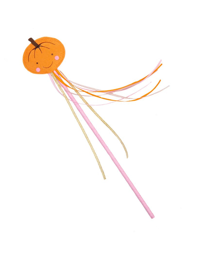A whimsical smiling pumpkin wand with colorful ribbon streamers