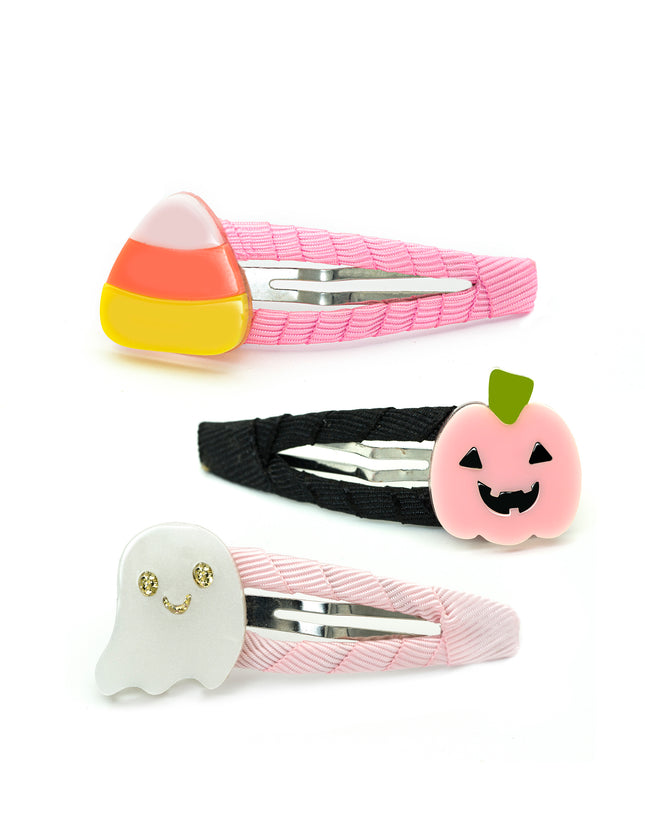 Three Halloween-themed hair clips: a pink candy corn clip, a black jack-o'-lantern clip, and a pink ghost clip.