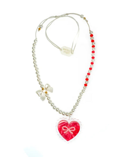 Red bow heart pendant necklace with white pearls. 