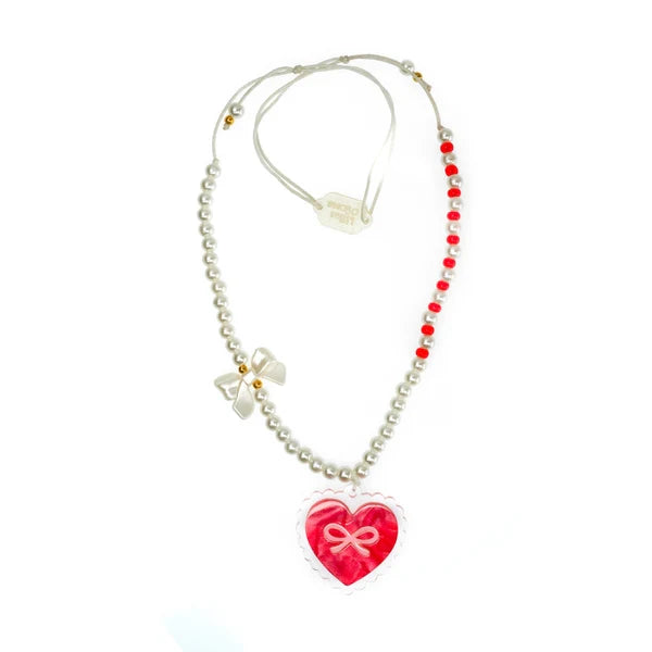 Red bow heart pendant necklace with white pearls. 