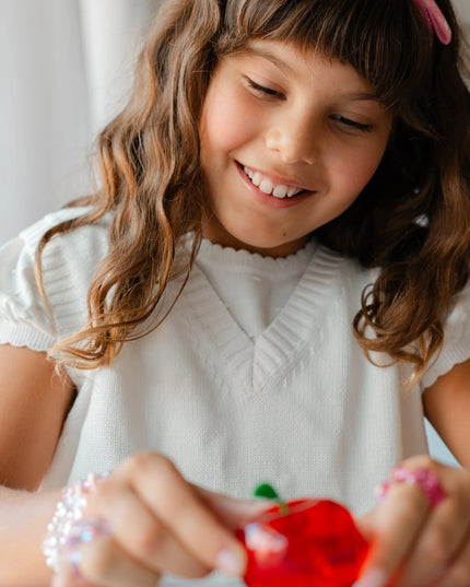 Girl Holding Apple Shaped Jewelry Making Bead Kit