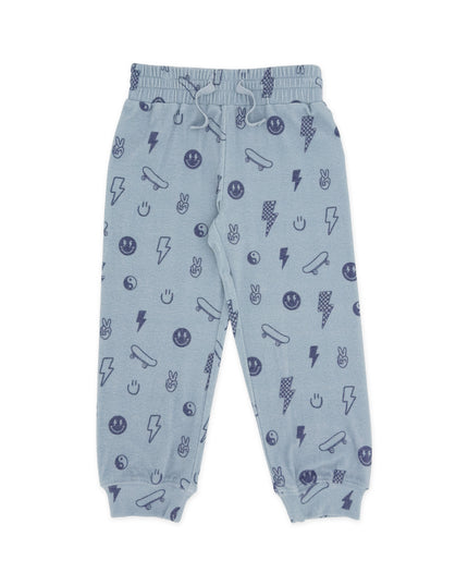 Light blue joggers with an all-over dark blue graphic print of skateboards, lightning bolts, smiley faces, and other doodles