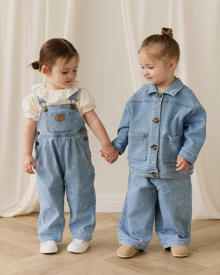 Girls wearing denim outfits holding hands
