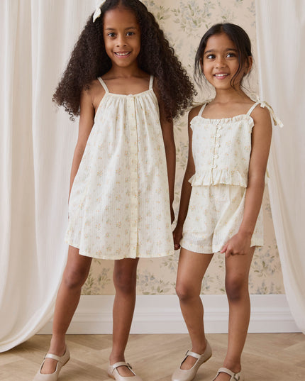 Girls wearing coordinating cream and floral outfits