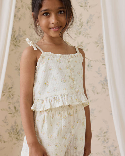 Girl wearing cream and floral top and shorts