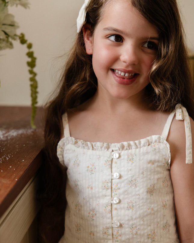 Girl wearing cream and floral top