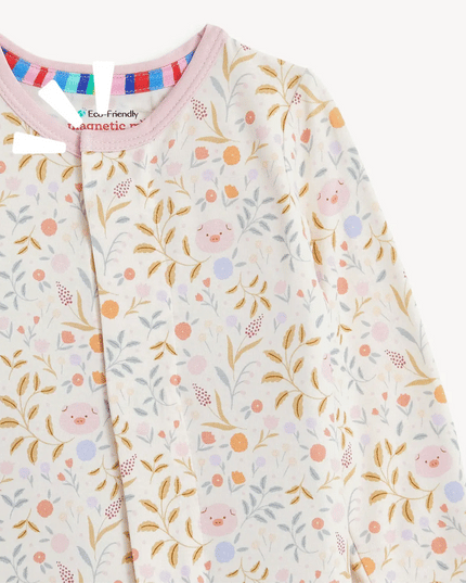 Floral and piglet patterned baby onesie