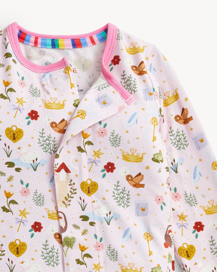 A baby convertible pink sleeper with a colorful woodland fairytale pattern of trees, flowers, and crowns, finished with pink trim on the collar.