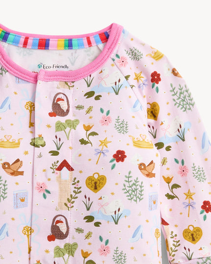 A baby convertible pink sleeper with a colorful woodland fairytale pattern of trees, flowers, and crowns, finished with pink trim on the collar.