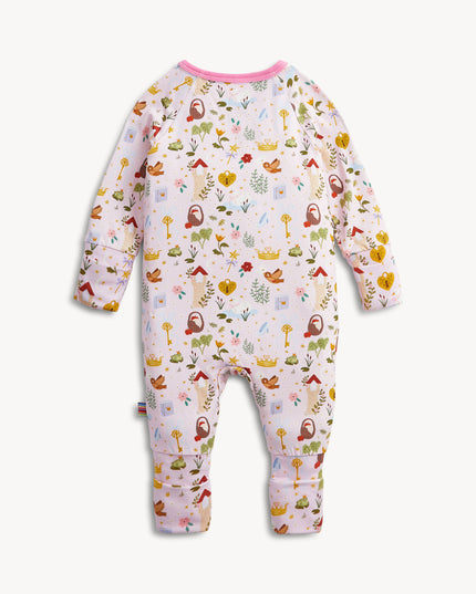 A baby convertible pink sleeper with a colorful woodland fairytale pattern of trees, flowers, and crowns, finished with pink trim on the collar.