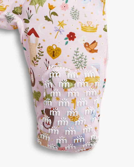 A baby convertible pink sleeper with a colorful woodland fairytale pattern of trees, flowers, and crowns, finished with pink trim on the collar.