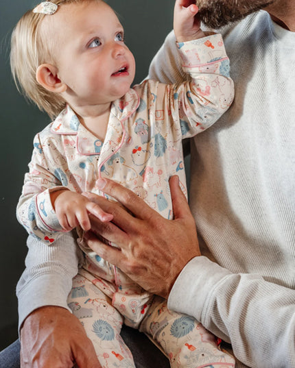 Baby wearing coverall pajamas with poodle print 