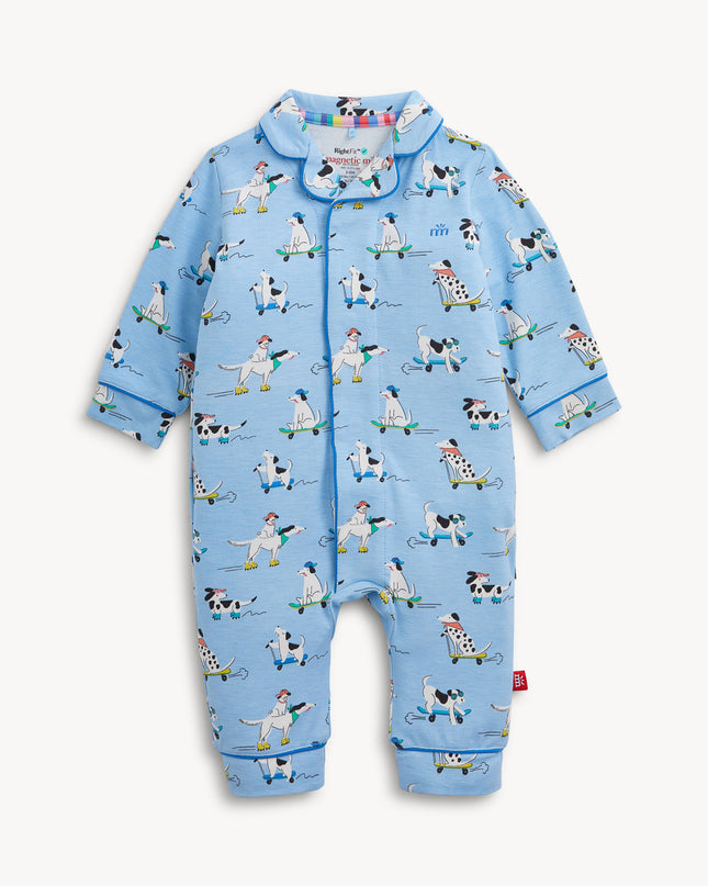 A light blue long-sleeve pajama coverall with a cartoon dog pattern on roller skates, featuring a collar and magnetic closure.