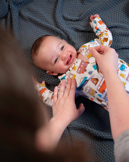 baby wearing onesie with colorful camping and van pattern