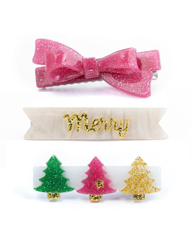 Clip set featuring a pink glitter bow clip, a pearly “Merry” clip, and a clip featuring a row of glittery Christmas trees