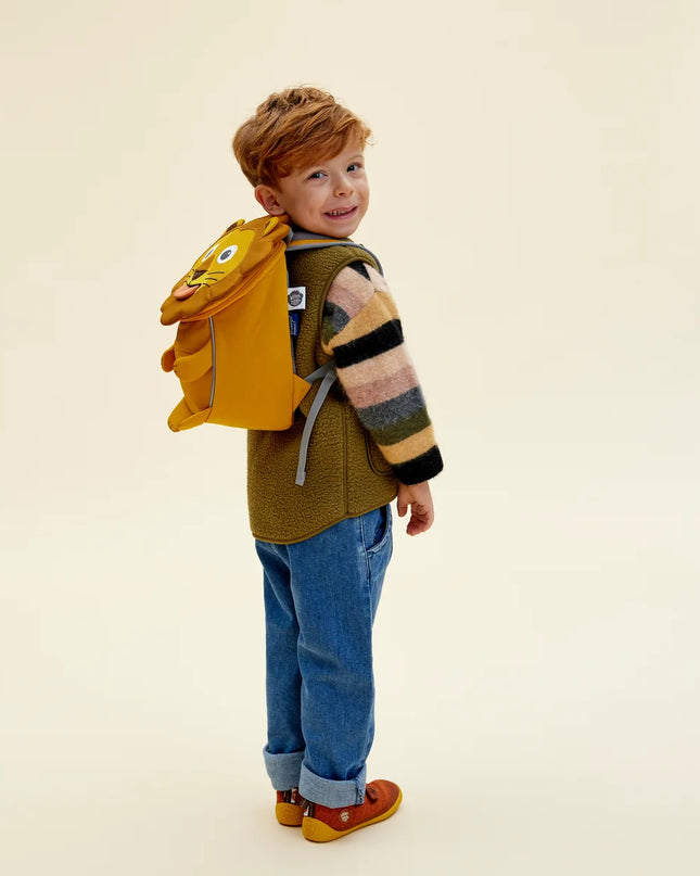 Boy wearing a Lion shaped children's backpack