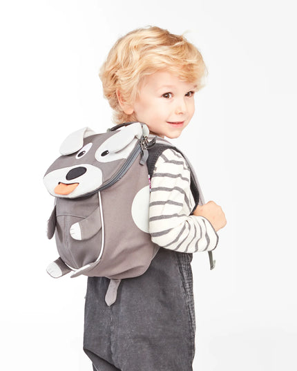 Child wearing a gray dog backpack