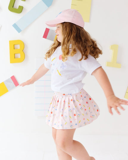 Girl wearing white t-shirt and Pink skort with back to school design