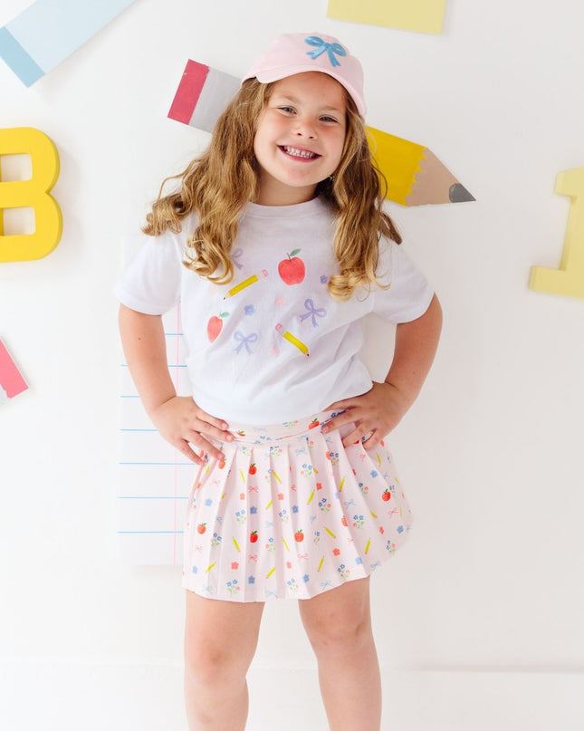Girl wearing white t-shirt and Pink skort with back to school design
