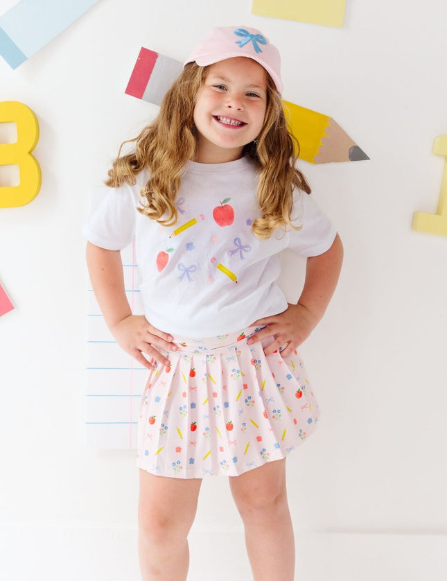 Girl wearing white t-shirt and Pink skort with back to school design