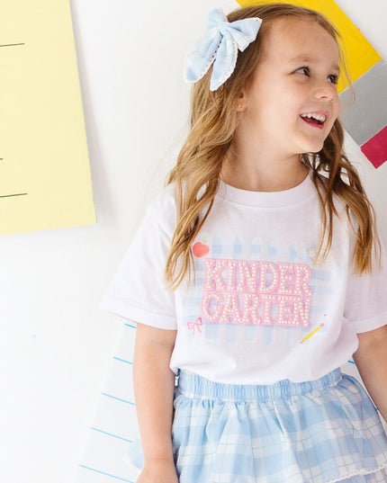 Girl wearing White T-Shirt with Kindergarten Pearl Patch