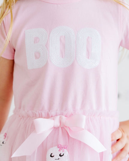 A girl wearing a pink tutu dress with sequin 'Boo' and ghost details