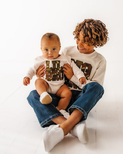 boys wearing matching big bro and lil bro camouflage patch sweatshirts