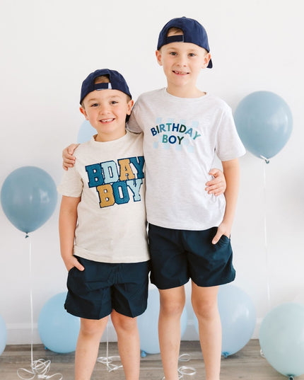 Two children wearing birthday boy shirts