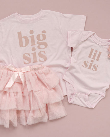 Flat lay of 'big sis' and 'lil sis' clothing