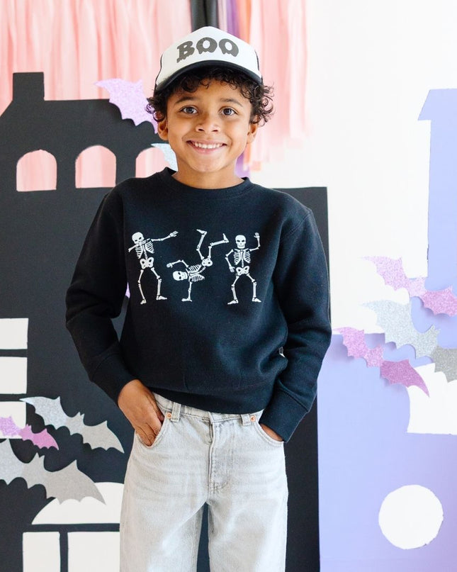 Boy wearing Black Sweatshirt with dancing skeletons and "boy" trucker hat