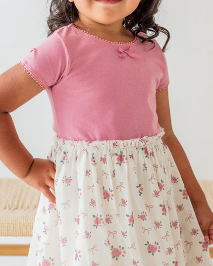 Girl wearing Tutu dress with mauve top and ivory coquette bow and floral tutu
