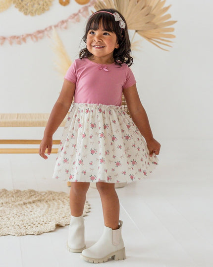 Girl wearing Tutu dress with mauve top and ivory coquette bow and floral tutu