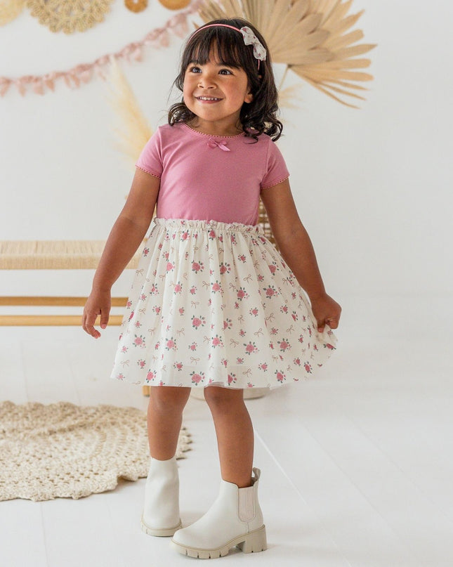 Girl wearing Tutu dress with mauve top and ivory coquette bow and floral tutu