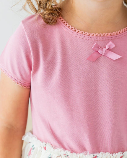 Girl wearing Tutu dress with mauve top and ivory coquette bow and floral tutu