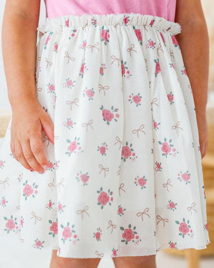 Girl wearing Tutu dress with mauve top and ivory coquette bow and floral tutu