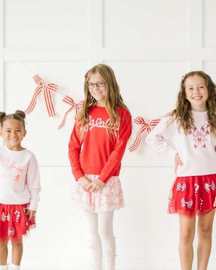 Girls wearing festive Christmas outfits 