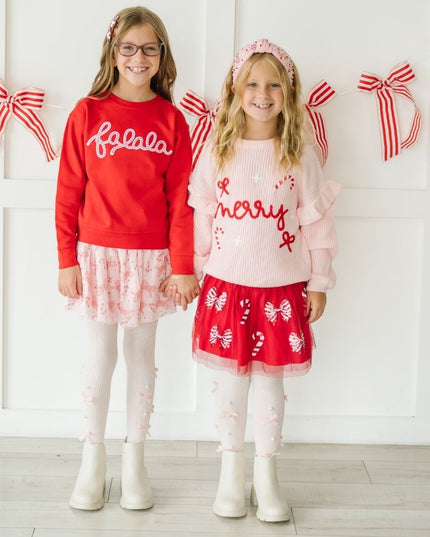 Girls wearing festive Christmas outfits 