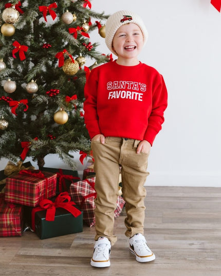 Boy wearing red sweatshirt with 'Santa's Favorite' graphic