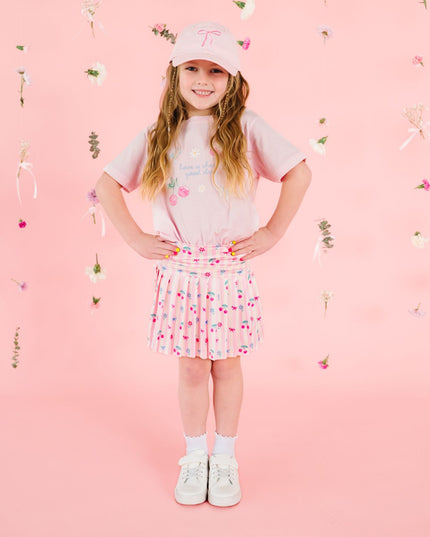 Girl wearing pink outfit with cherry design