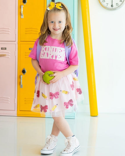 Girl holding an apple wearing Pink Short Sleeve T-Shirt with Kindergarten Sequin Patch and tutu with sequin pencils and bows