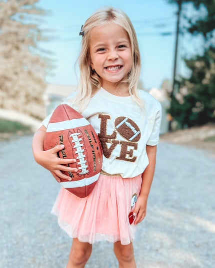 Girl holding a football and wearing "Love" Football Patch Short Sleeve T-Shirt
