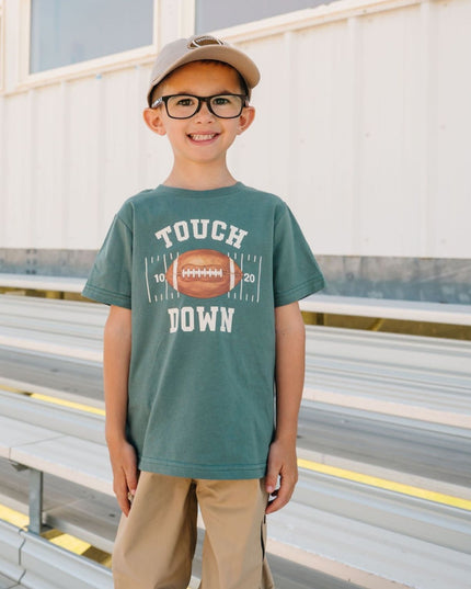 Boy wearing Green t-shirt with touch down football graphic